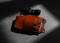 Orange leather holster with five scissor spaces