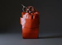 Orange leather holster with five scissor spaces