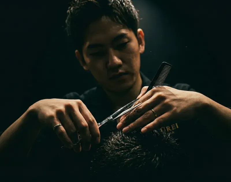 Stylist cutting hair with scissors
