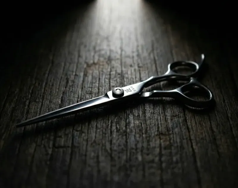 A pair of scissors on a wooden table