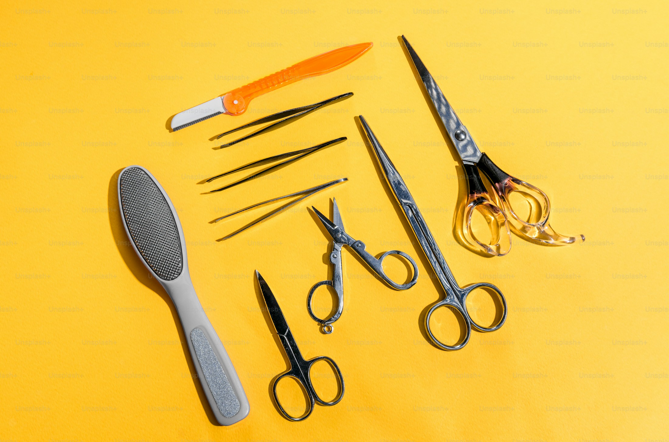 Ichiro scissors and styling tools organised on a yellow backdrop