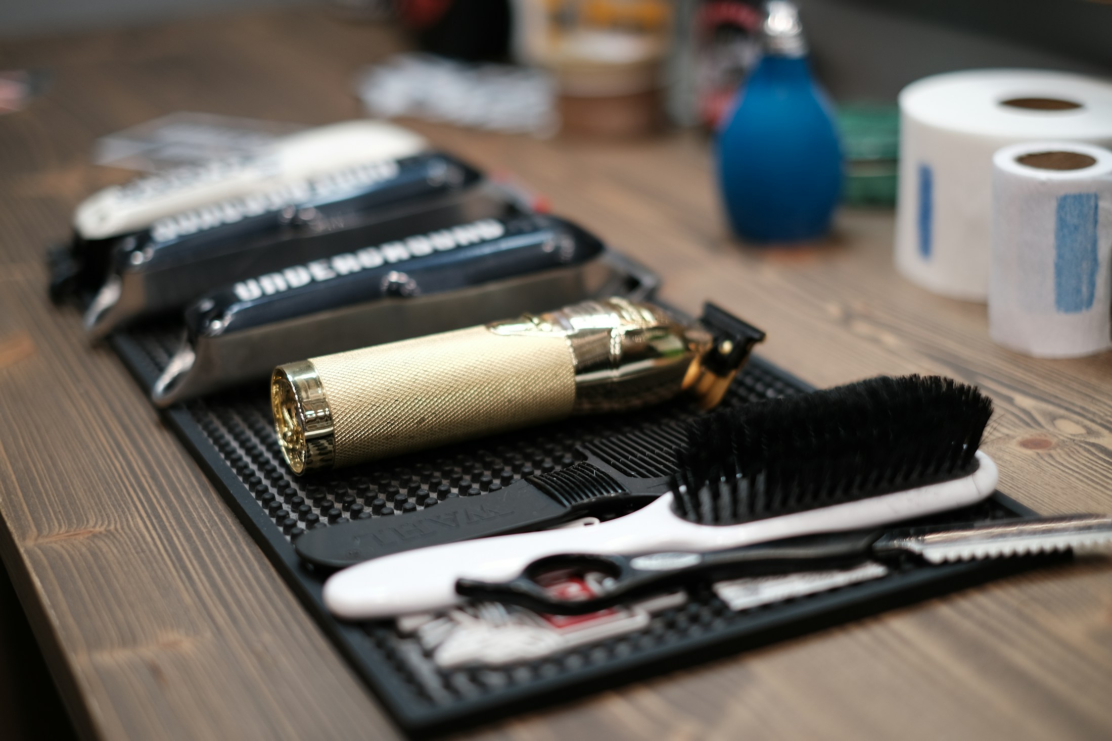 Joewell scissors, combs, and clippers organised on a station mat