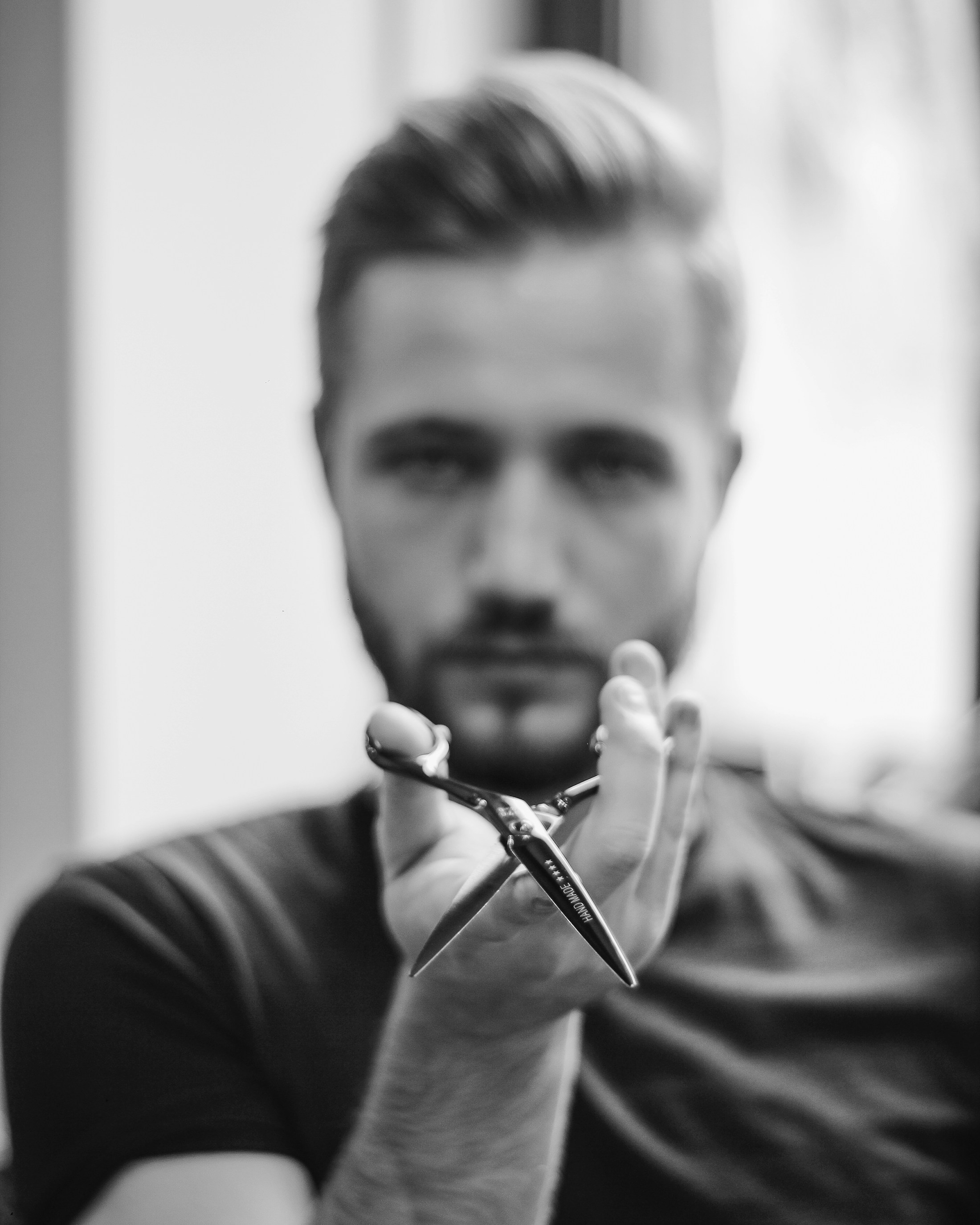 Barber detailing a skin fade with Kamisori scissors