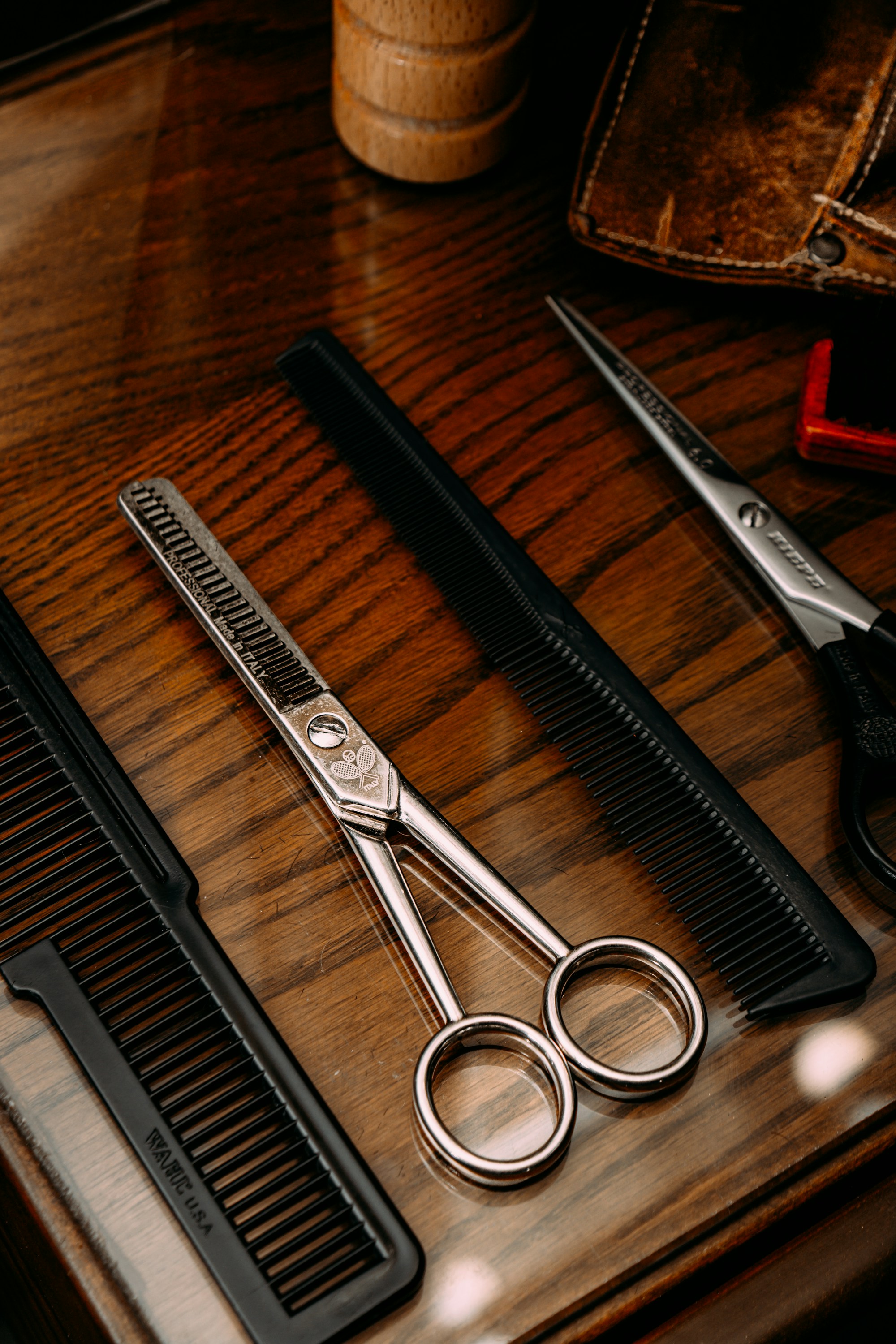 Selection of professional scissors laid out on a workbench