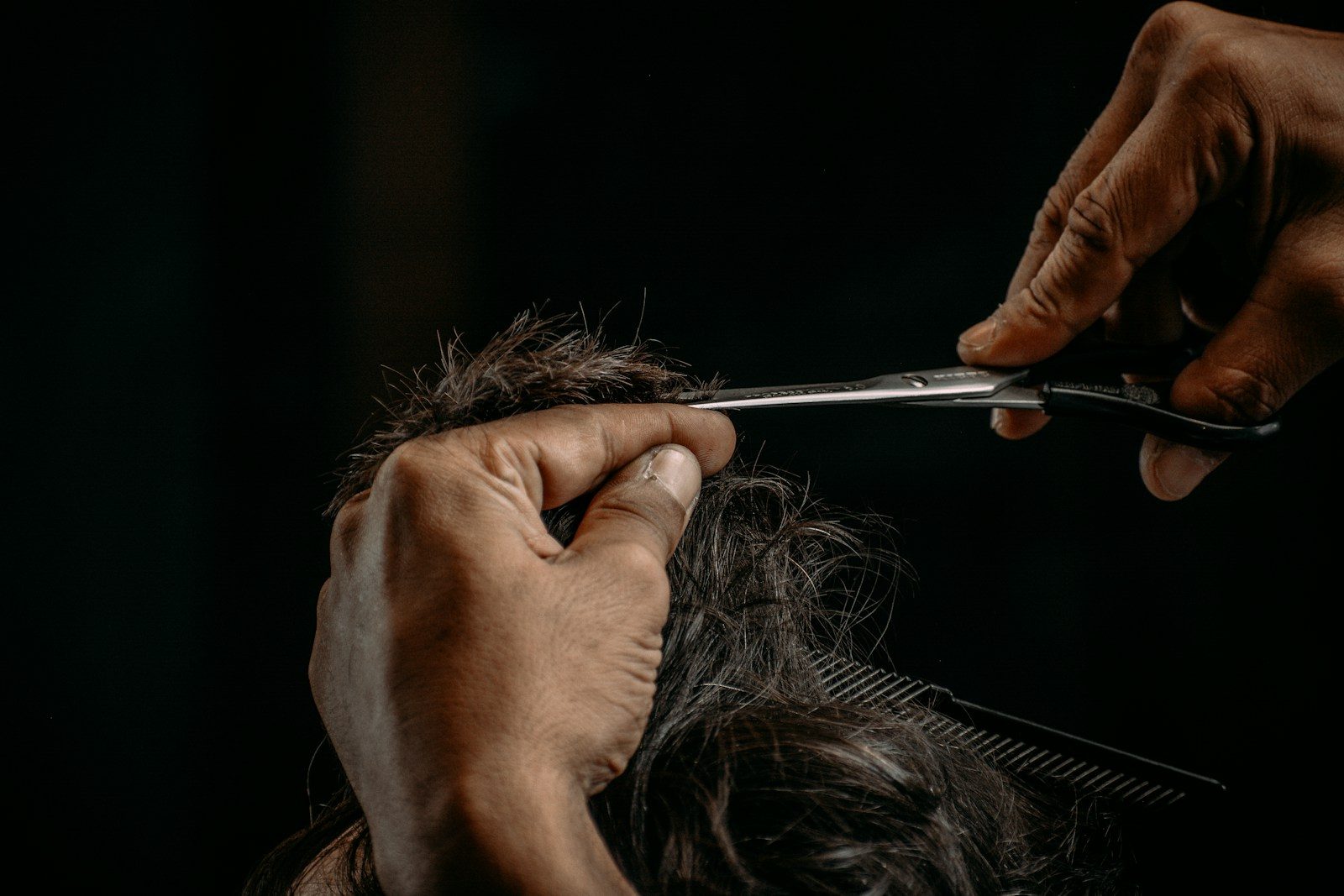 Stylist using swivel scissors around a client's head