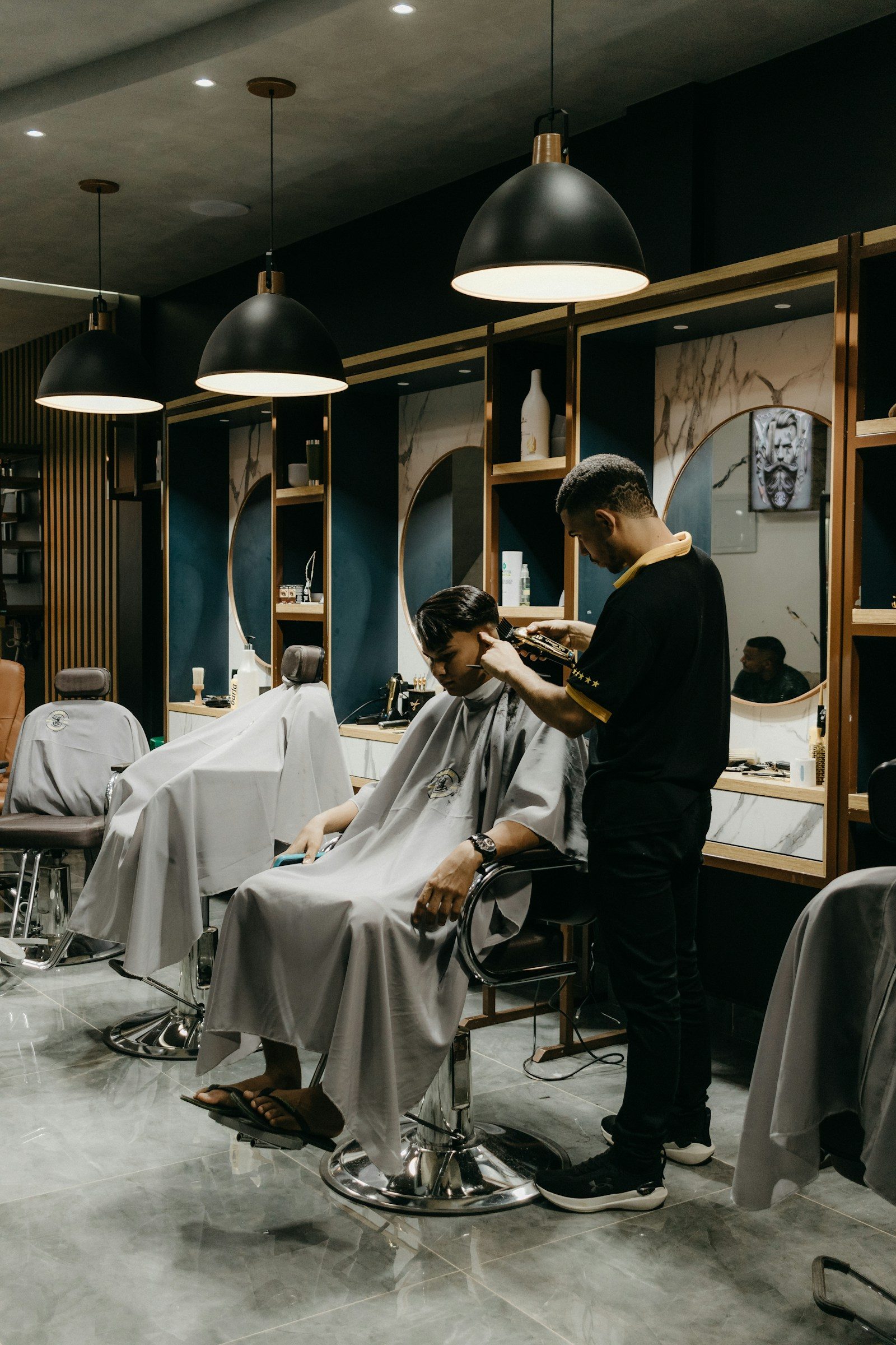 Stylist detailing a cut in a minimalist salon