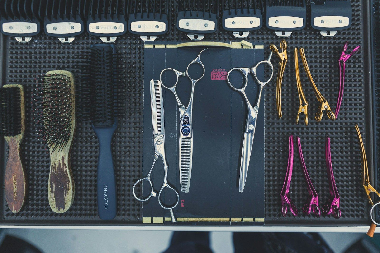 Line-up of scissors and combs on a salon trolley